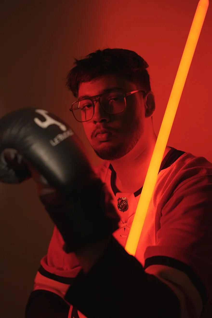Praneetnath Tiwari in red light with a boxing glove and a glowing light bar